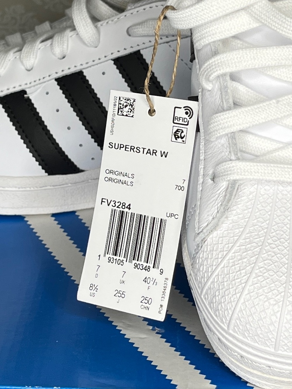 Adidas White Sneakers with Black Stripes and Gold Tongue Logo